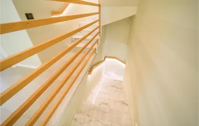 a staircase in a house with wooden railings at 5 Bedroom Nice Home In Trappeto in Trappeto