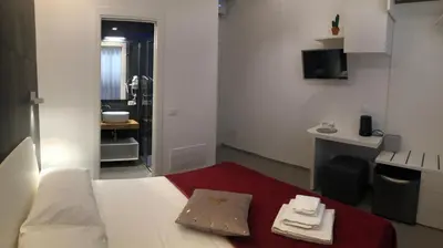 a small room with a bed and a bathroom at Porta del Golfo Apartments & Suites in Castellammare del Golfo