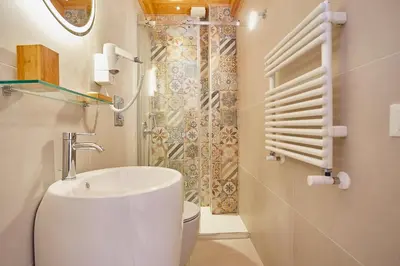 a bathroom with a sink and a toilet and a shower at Porta del Golfo Apartments & Suites in Castellammare del Golfo