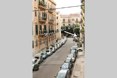 a row of cars parked on a street with buildings at A casa di Enza B&B in Palermo
