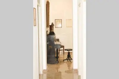 a hallway with a table and a chair in a room at A casa di Enza B&B in Palermo