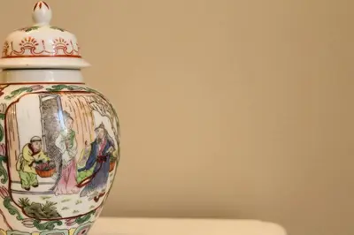 a vase with a painting on it sitting on a table at A casa di Enza B&B in Palermo
