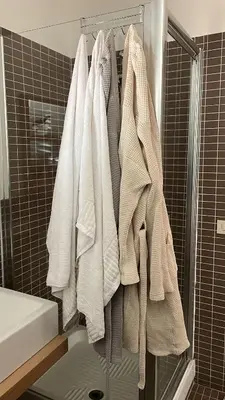 a group of towels hanging on a rack in a bathroom at Campofelice Casa vacanza in Palermo