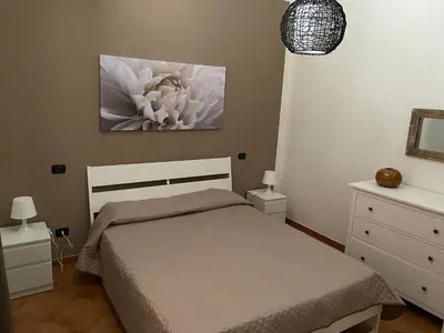 a bedroom with a bed and a painting on the wall at Villa Piruzzu CV Torre Mulinazzo app P in Cinisi