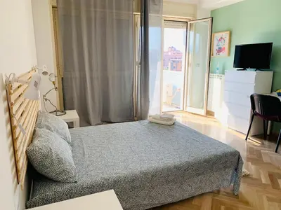 a bedroom with a bed and a large window at Sostegno d'amore in Palermo
