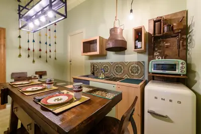 a kitchen with a wooden table and a refrigerator at CELSO 14 in Palermo