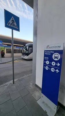 a blue sign at a gas station with a bus at Balsamotto - Appartamento e parcheggio in Palermo