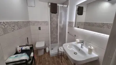 a white bathroom with a sink and a toilet at Balsamotto - Appartamento e parcheggio in Palermo