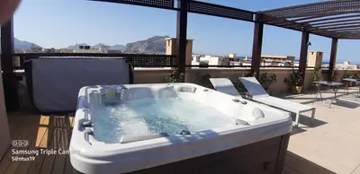 a bath tub sitting on a balcony with chairs at Balsamotto - Appartamento e parcheggio in Palermo