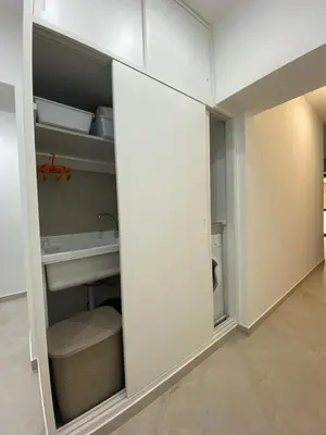 a white cabinet with a door in a room at Momenti e Monumenti in Palermo