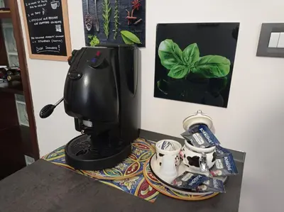 a coffee maker sitting on a counter with a tray with cups at Essenze di Sicilia Appartamento Cavour in centro in Palermo