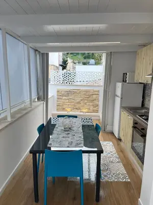 a dining room with a table and chairs in a kitchen at Home holiday Kalanto in Castellammare del Golfo