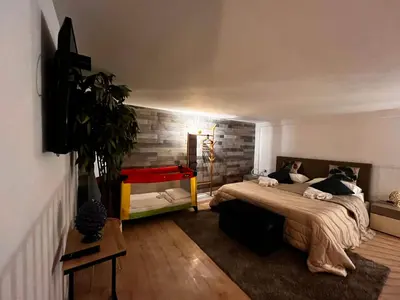a bedroom with a large bed and a red table at Casa vacanze Loft del Borgo in Palermo