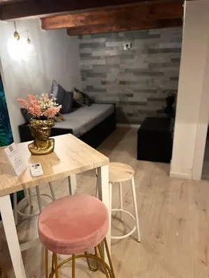 a living room with a table and two stools at Casa vacanze Loft del Borgo in Palermo
