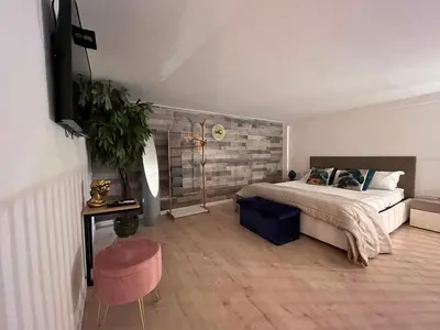 a bedroom with a bed and a table and a chair at Casa vacanze Loft del Borgo in Palermo
