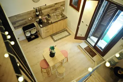 an overhead view of a kitchen with a table and chairs at Casa vacanze Loft del Borgo in Palermo