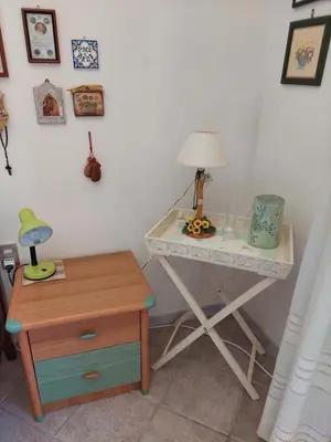 a desk with a lamp and a table with a nightstand at Villa Maricetta in Castellammare del Golfo