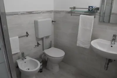 a bathroom with a toilet and a sink at Rahal B&B in Palermo