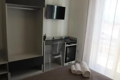 a room with a desk and a tv on the wall at Rahal B&B in Palermo