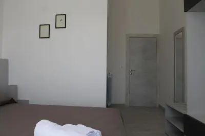 a bedroom with a bed and a door to a hallway at Rahal B&B in Palermo