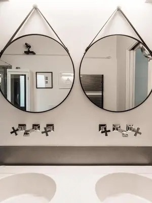 a room with a bed and a desk and a mirror at Casa con Giardino all'ex Fabbrica di Pomodoro by Wonderful Italy in Palermo