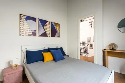 a bedroom with a bed with blue pillows at Casa con Giardino all'ex Fabbrica di Pomodoro by Wonderful Italy in Palermo