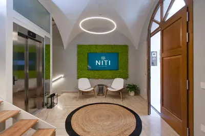 a meeting room with a nitt sign on the wall at NITI Palace in Castellammare del Golfo