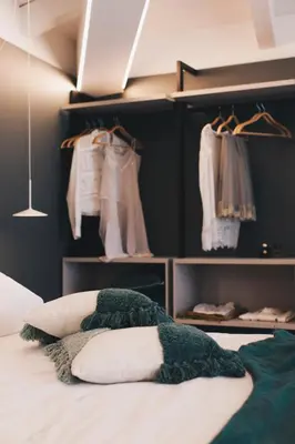a bedroom with a bed and some clothes at NITI Palace in Castellammare del Golfo