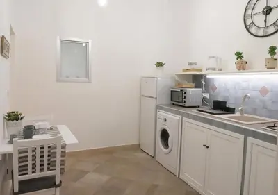 a kitchen with a sink and a washing machine at Casa Kilò in Palermo