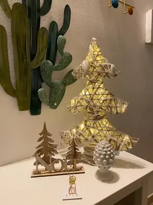 a small christmas tree on a table next to a cactus at Casa Kilò in Palermo