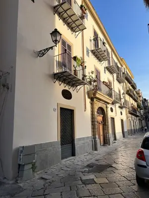 a building with balconies on the side of a street at Casa Kilò in Palermo