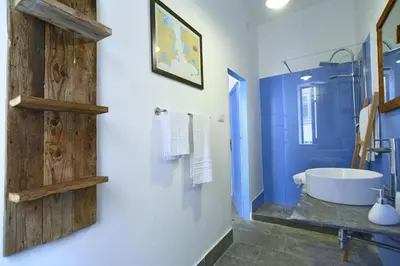 a blue bathroom with a tub and a sink at Casa Azul in Terrasini