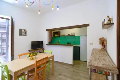 a kitchen and dining room with a table and chairs at Casa Azul in Terrasini