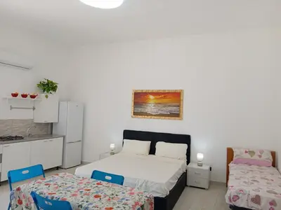 a bedroom with a bed and two chairs at Villa Rosa in Castellammare del Golfo