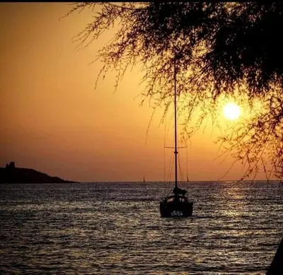 a sail boat in the water at sunset at Dolce Casa in Palermo