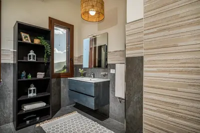 a bathroom with a sink and a mirror at Villa Azuria con Piscina Privata Vista Mare in Scopello