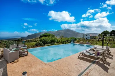 a swimming pool with a view of the mountains at Villa Azuria con Piscina Privata Vista Mare in Scopello