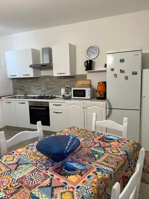 a kitchen with a table with a bowl on it at Trentuno Mondello Apartments in Mondello