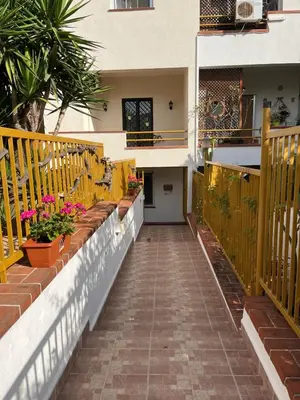 a walkway leading to a house with flowers on it at Trentuno Mondello Apartments in Mondello