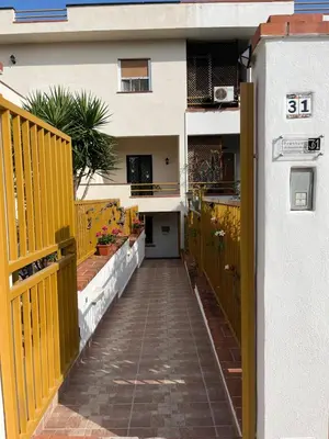 a hallway of a house with a yellow fence at Trentuno Mondello Apartments in Mondello