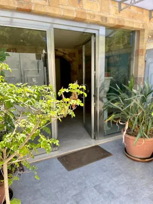 a glass entrance to a house with potted plants at La Casa di Martorana in Palermo