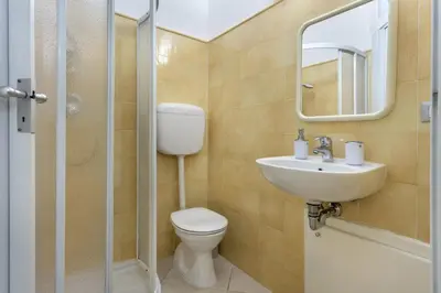 a bathroom with a toilet and a sink and a mirror at La Casa di Martorana in Palermo