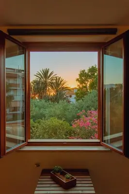a window with a view of a garden at Casa Vespucci in Isola delle Femmine
