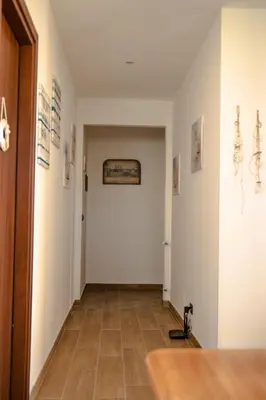 a hallway with white walls and a tile floor at Casa Vespucci in Isola delle Femmine