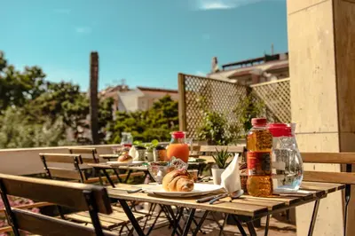 an outdoor table with food and condiments on a patio at Casa Vespucci in Isola delle Femmine