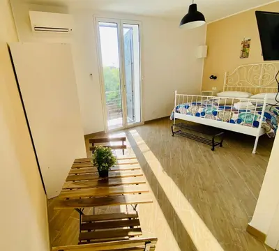 a small room with a bed and a window at Pindemonte Suites in Palermo