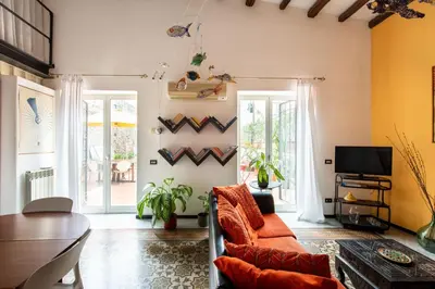 a living room with a couch and a tv at Iconic Apartment in Porta Carini by Wonderful Italy in Palermo