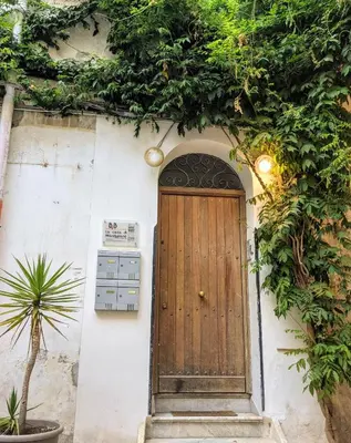 a wooden door on the side of a building at Iconic Apartment in Porta Carini by Wonderful Italy in Palermo