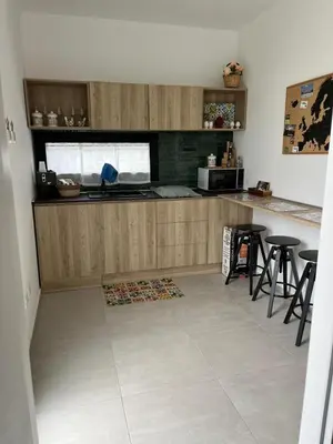 a kitchen with a counter and stools in a room at Casa RALIVO di Sicilia in Balestrate
