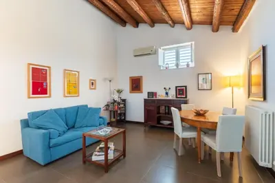 a living room with a blue couch and a table at A Casa Dell' Artista in Palermo